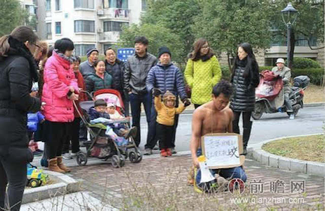 Anh Wang quỳ trước chung cư, nơi anh sống c&ugrave;ng vợ. Ảnh: Shanghaiist