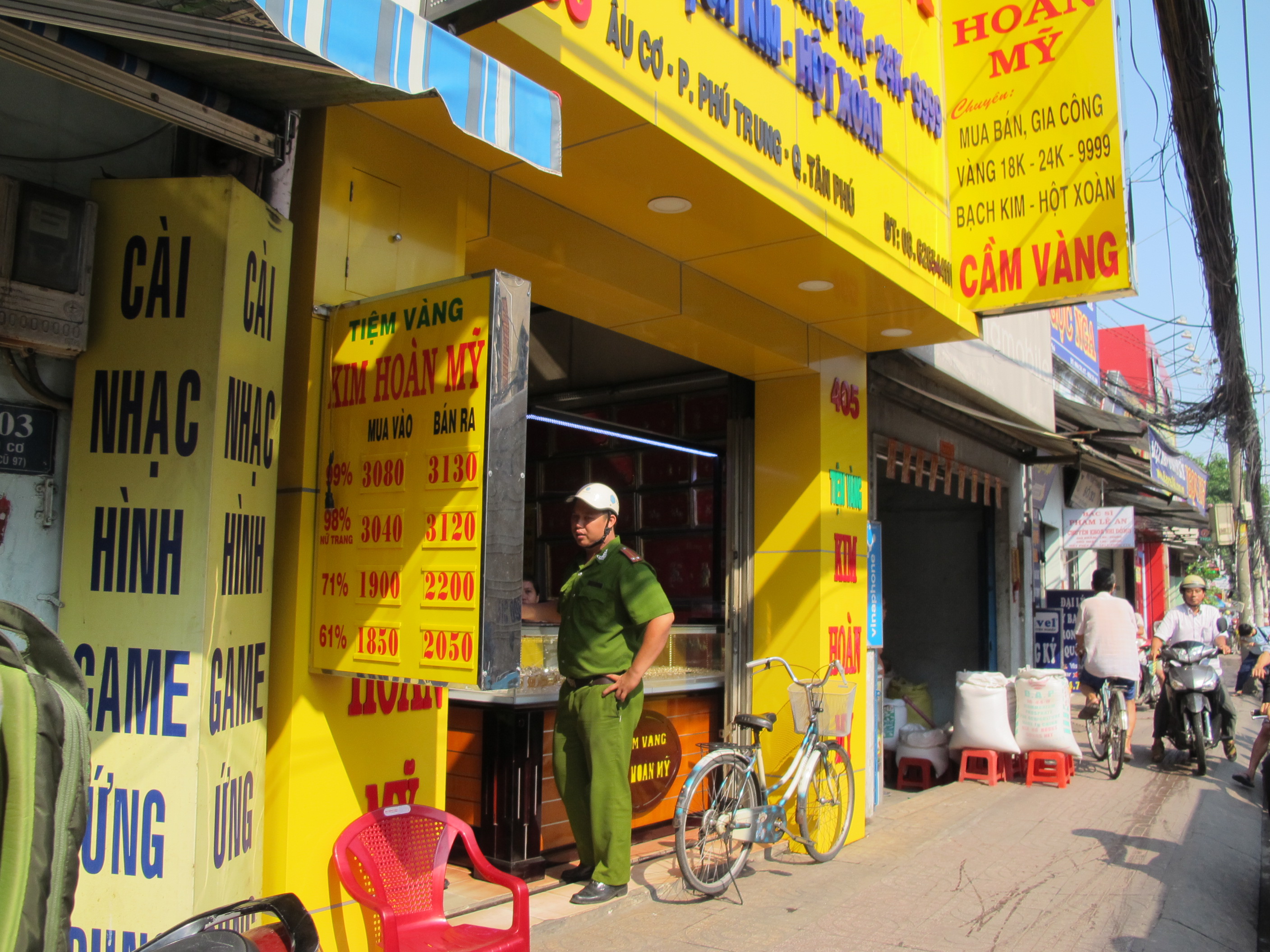 Kẻ cướp đeo găng tay, khẩu trang v&agrave;o hỏi mua v&agrave;ng. Trong ảnh: c&ocirc;ng an đang hỏi th&ocirc;ng tin từ chủ tiệm v&agrave;ng