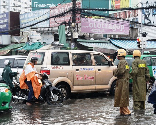 Lực lượng CSGT cũng phải b&igrave; b&otilde;m l&ocirc;i nước để đứng điều tiết giao th&ocirc;ng