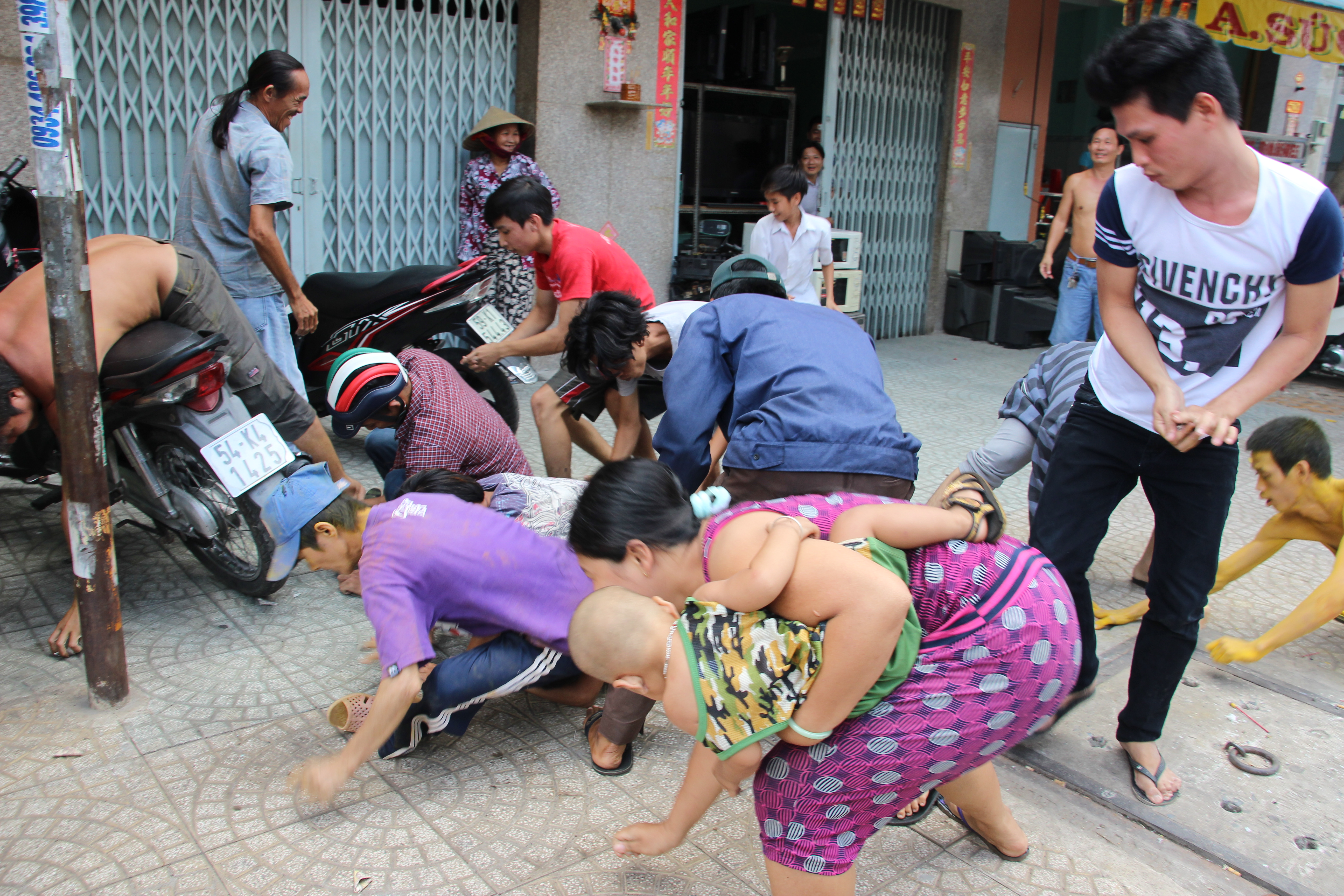 Vừa bế con vừa nhảy v&agrave;o đ&aacute;m đ&ocirc;ng để tham gia giật c&ocirc; hồn