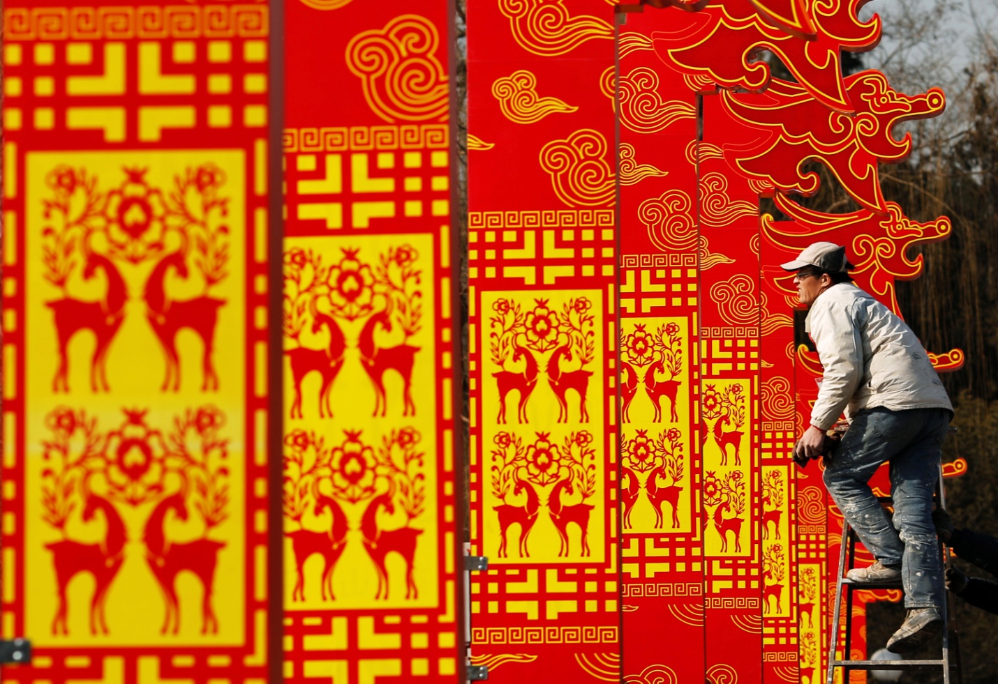 A man installs decorations for the upcoming Chinese Lunar New Year celebrations at Taoranting park in Beijing February 9, 2015. Photo by Kim Kyung-Hoon/REUTERS.