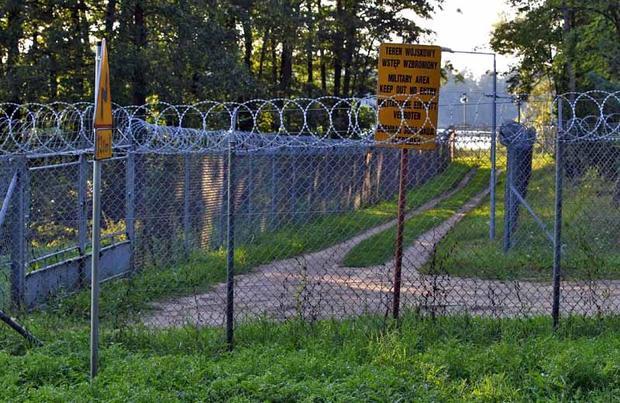 Barbed wire fence surrounds a military area in the forest in Stare Kiejkuty village  close to Szczyt...