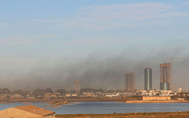 Smoke rises after an airstrike hit Maitiga airport early Thursday morning, in Tripoli