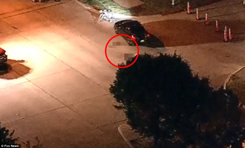 A body was seen lying next to the suspects vehicle as bomb squad robots scoured the area in the aftermath 