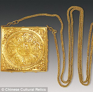 A fragrance box with gold chain. It is decorated with lotus petals and seven characters written in Sanskrit
