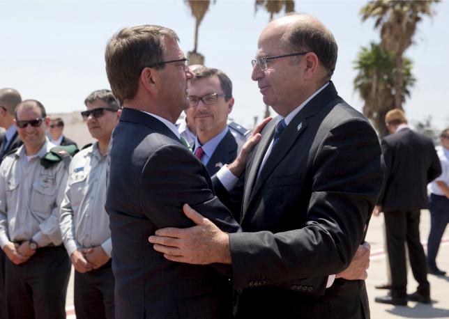 U.S. Secretary of Defense Ash Carter (L) and Israels Defence Minister Moshe Yaalon embrace on the tarmac at Ben Gurion International Airport near Tel Aviv, Israel, before Carters departure July 21, 2015. REUTERS/Carolyn Kaster/Pool