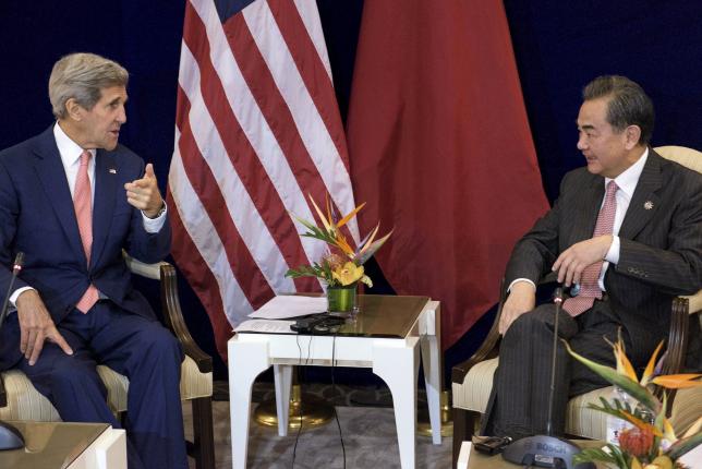 US Secretary of State John Kerry (L) and Chinas Foreign Minister Wang Yi talk before a bilateral meeting at the Putra World Trade Center August 5, 2015 in Kuala Lumpur, Malaysia. REUTERS/Brendan Smialowski/Pool