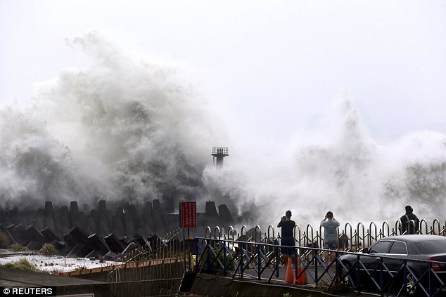 In the northeastern coastal town of Nanfangao in Ilan county, northern Taiwan, people take pictures of waves