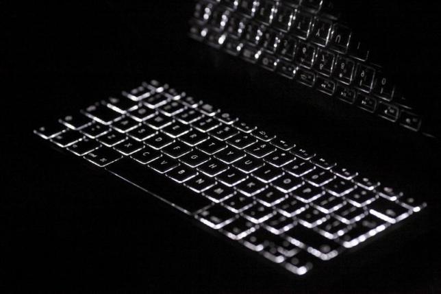Backlit keyboard is reflected in screen of Apple Macbook Pro notebook computer in Warsaw February 6, 2012. REUTERS/Kacper Pempel