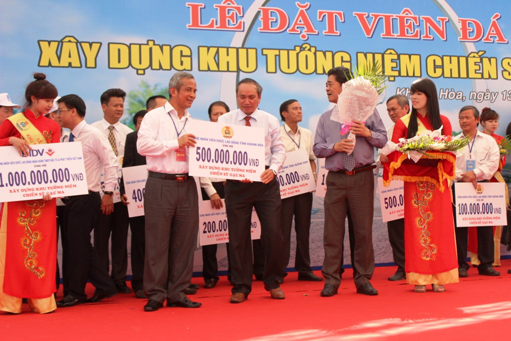 Ông Đặng Ngọc Tùng (bìa trái), tiếp nhận ủng hộ kinh phí xây dựng Khu tưởng niệm chiến sĩ Gạc Ma từ đại diện LĐLĐ tỉnh Khánh Hòa ẢNH: KỲ NAM