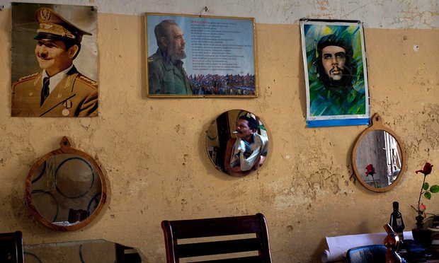 Ảnh của c&aacute;c &ocirc;ng Ra&uacute;l Castro, Fidel Castro v&agrave; Ernesto &lsquo;Che&rsquo; Guevara (từ tr&aacute;i qua) tr&ecirc;n một bức tường ở Havana. Ảnh: AP