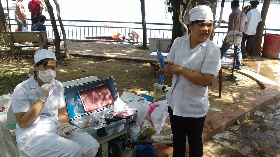 
C&aacute;n bộ y tế v&agrave; m&ocirc;i trường t&uacute;c trực lấy mẫu nước
