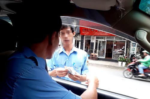 Ngang nhiên chiếm đường, thu tiền đậu ô tô - Ảnh 1.
