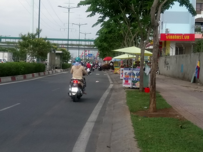 Các xe bán nước uống, thức ăn, thuốc lá kiểu này sẽ dễ dàng kéo đi khi thấy lực lượng chức năng. Ảnh chụp trên đường Phạm Văn Đồng (đoạn thuộc địa bàn quận Gò Vấp và Bình Thạnh)