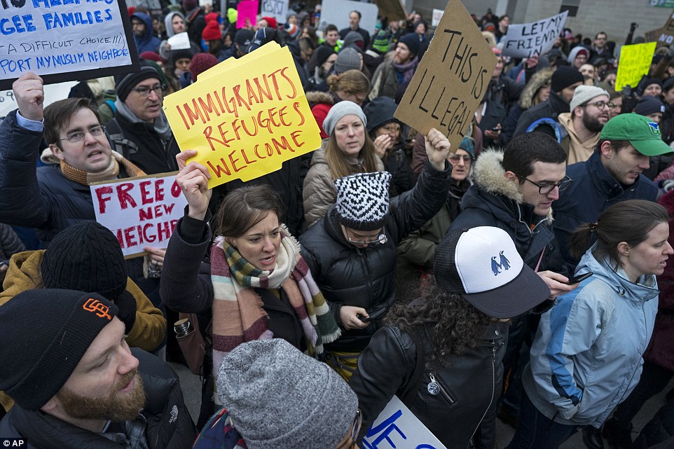'This is illegal': Demonstrators gathered outside JFK Saturday for a long protest after 12 refugees were detained inside