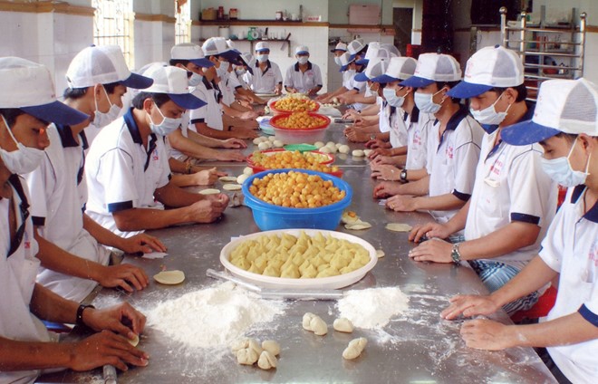 C&ocirc;ng nh&acirc;n C&ocirc;ng ty T&acirc;n Hu&ecirc; Vi&ecirc;n đang l&agrave;m b&aacute;nh p&iacute;a. Ảnh: Thanh Ch&acirc;u.