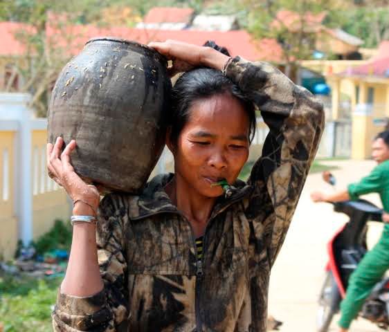 
Phụ nữ A Rem với ch&eacute; rượu đo&aacute;c mang từ trong rừng về
