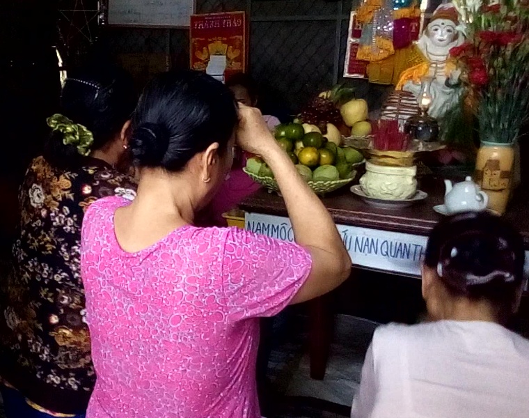Bệnh nhân quỳ lạy trước pho tượng đất sét do “mẹ Thơ” tự nắn (Ảnh cắt từ video clip).