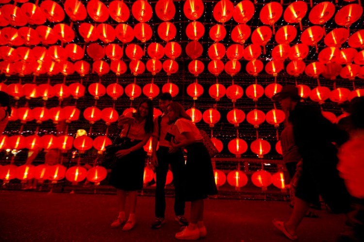 Người dân đi dạo ở con đường đỏ rực đèn lồng đón Tết ở thủ đô Bangkok – Thái Lan. Ảnh: REUTERS