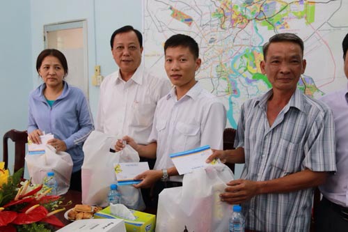 Ông Nguyễn Hữu Phát (thứ hai từ trái sang), Phó Bí thư Thường trực Đảng ủy Sở Giao thông Vận tải TP HCM, tặng quà Tết cho công nhân khó khăn Ảnh: KHÁNH AN