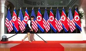 Worker vacuums spot where U.S. President Trump and North Koreaâs leader Kim are expected to shake hands