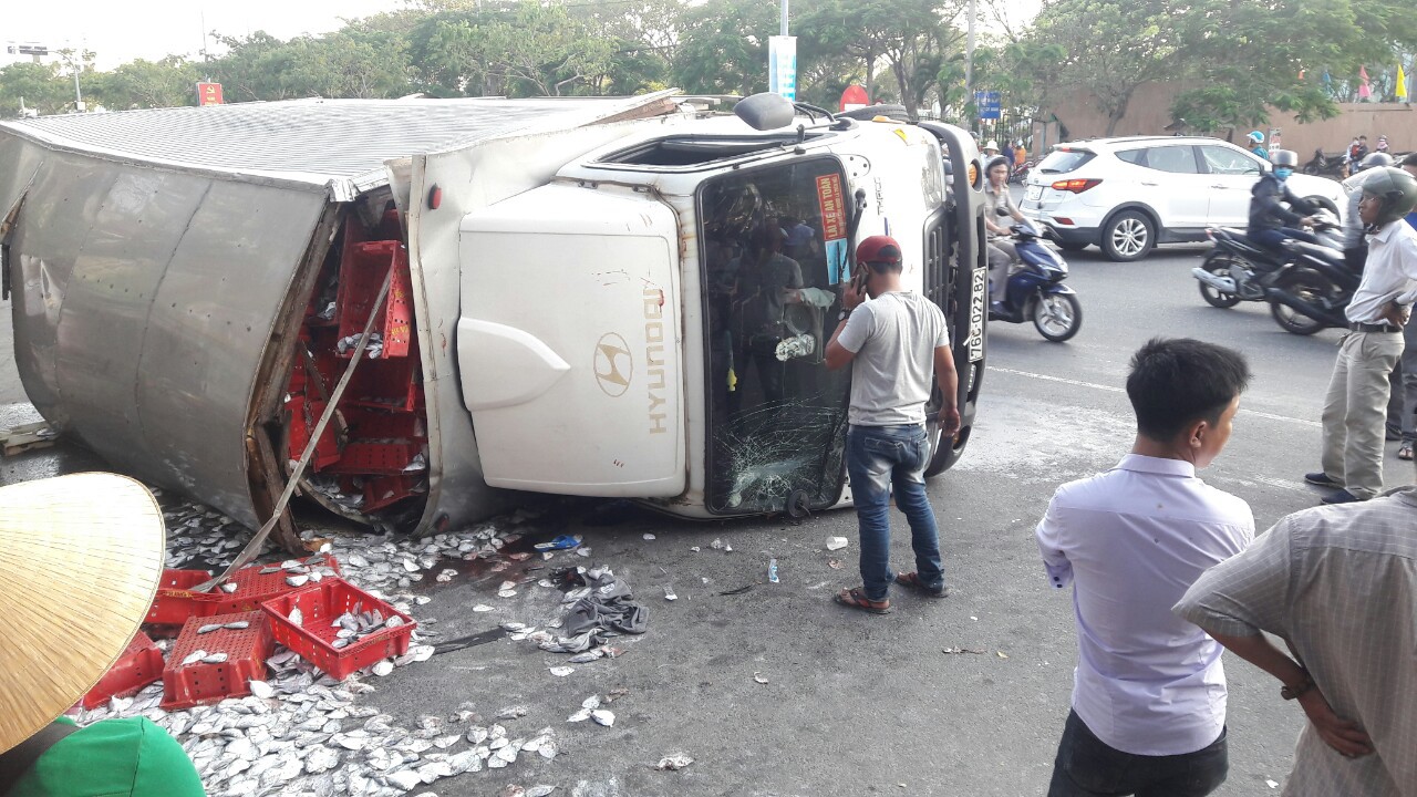 Xe tải mất l&aacute;i lật ngang, 2 tấn c&aacute; b&aacute;nh l&aacute;i tr&agrave;n xuống đường - Ảnh 2.