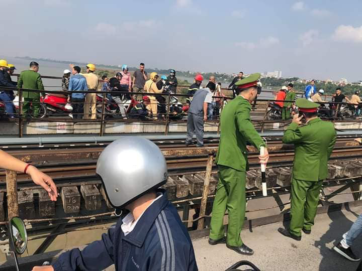 Thanh ni&ecirc;n buồn chuyện gia đ&igrave;nh &ocirc;m con nhỏ ngồi vắt vẻo tr&ecirc;n thanh giằng cầu Long Bi&ecirc;n - Ảnh 2.