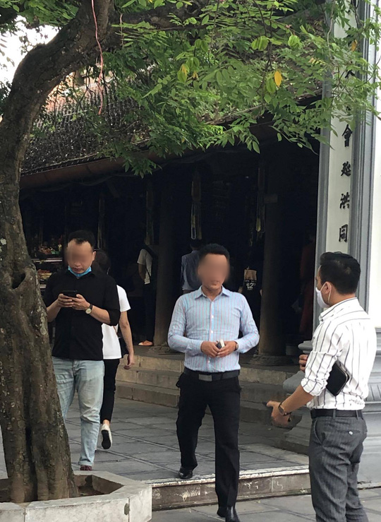 Người đàn ông không đeo khẩu trang tạo dáng chụp ảnh cạnh biển thông báo chống dịch Covid-19 - Ảnh 3.
