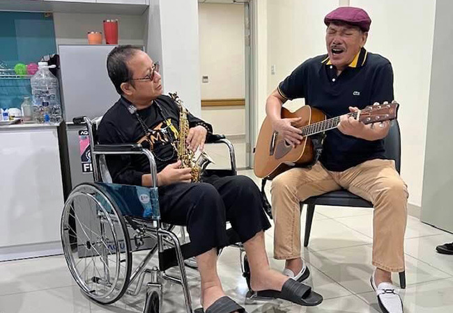 Nghệ sĩ Trần Mạnh Tuấn thổi saxophone c&ugrave;ng nhạc sĩ Trần Tiến đ&agrave;n h&aacute;t trong bệnh viện - Ảnh 1.