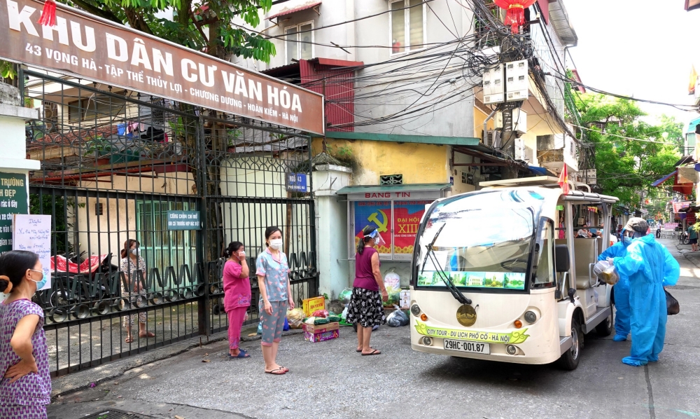 Xe điện chở lương thực v&agrave;o tận ng&otilde; hỗ trợ người d&acirc;n bị phong toả - Ảnh 1.