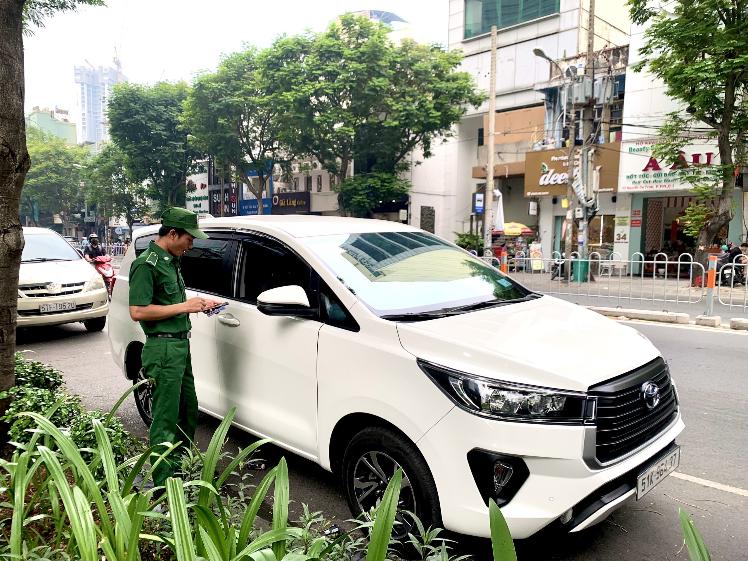Nhân viên thu phí hướng dẫn người dân đậu xe ở lòng đường trên đường Nguyễn Cư Trinh, quận 1, TP HCMẢnh: ÁI MY