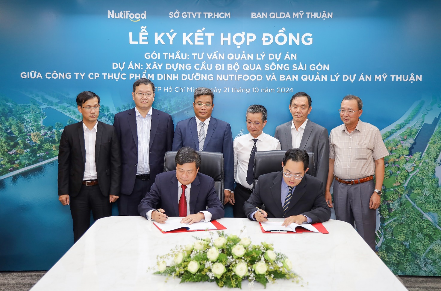 A group of men signing papers Description automatically generated