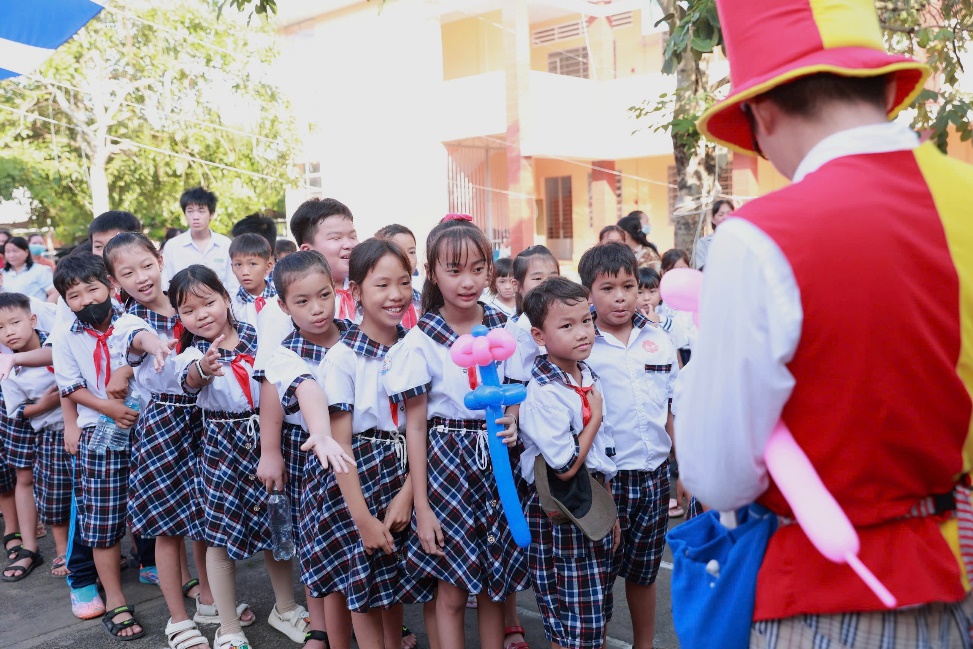 A group of children in school uniforms Description automatically generated