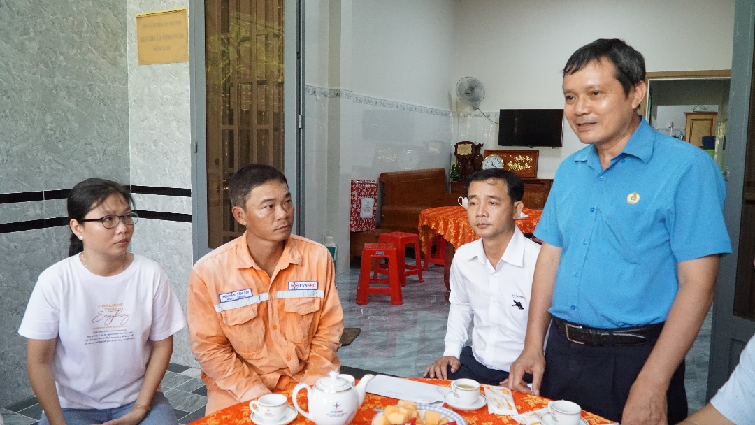 A group of men sitting around a table Description automatically generated