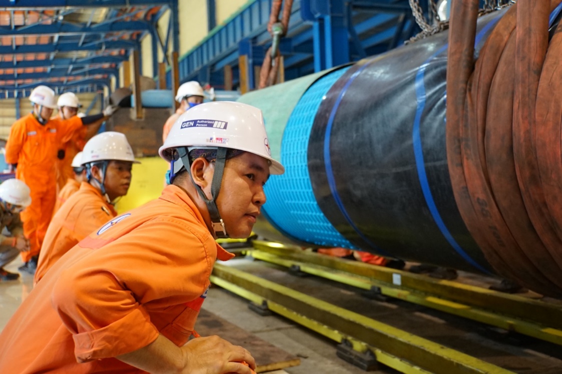 A group of men wearing hard hats Description automatically generated