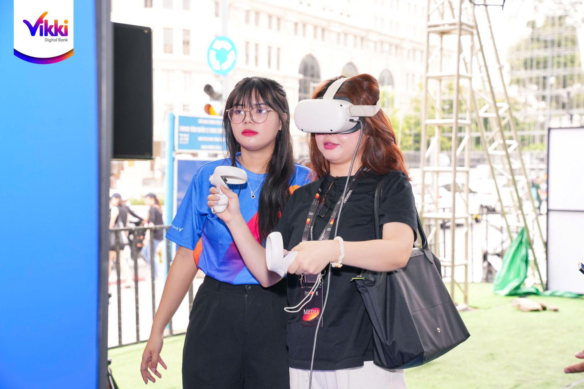 Two women wearing virtual reality headsets Description automatically generated