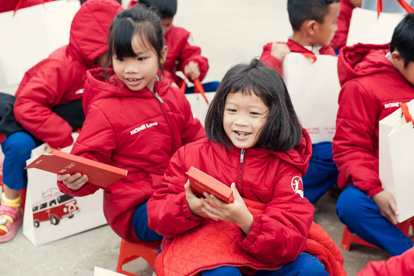 A group of children in red jackets Description automatically generated