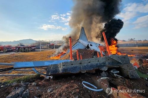 Flames rise from the wreckage of the Jeju Air passenger plane that crashed at the Muan International Airport in Muan, South Jeolla Province, about 288 kilometers southwest of Seoul, on Dec. 29, 2024, in this photo provided by a Yonhap reader. (PHOTO NOT FOR SALE) (Yonhap)