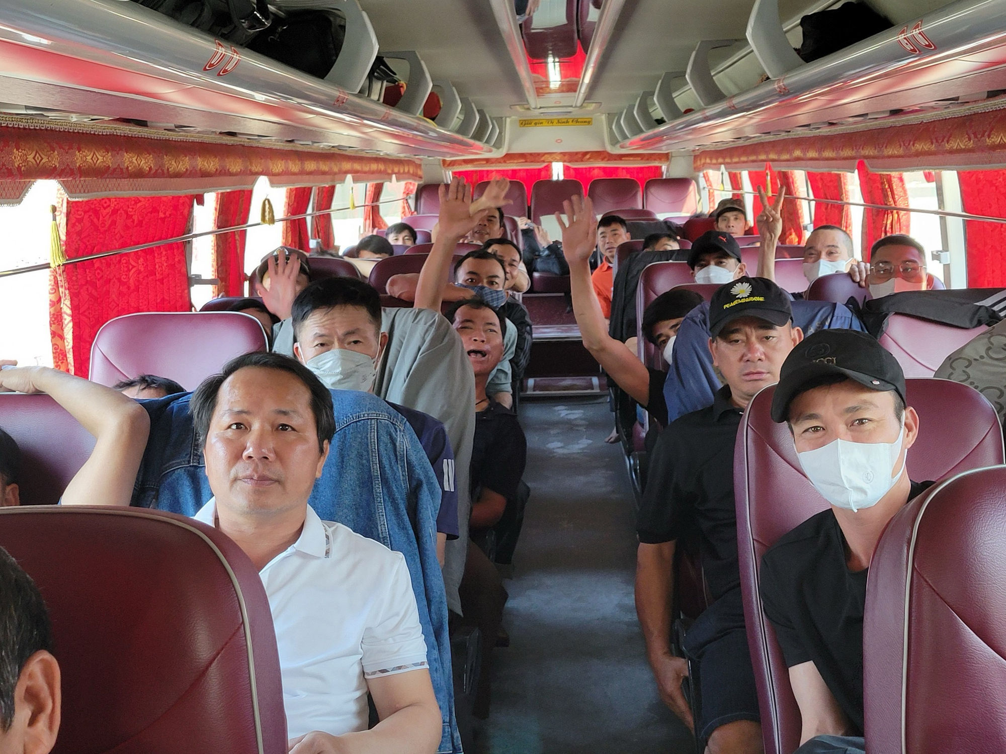 A group of people in a bus Description automatically generated