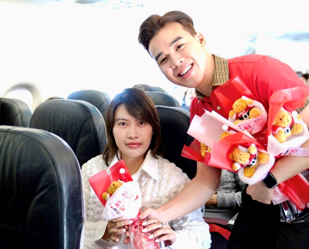 A person giving a bouquet of teddy bears to a person  Description automatically generated