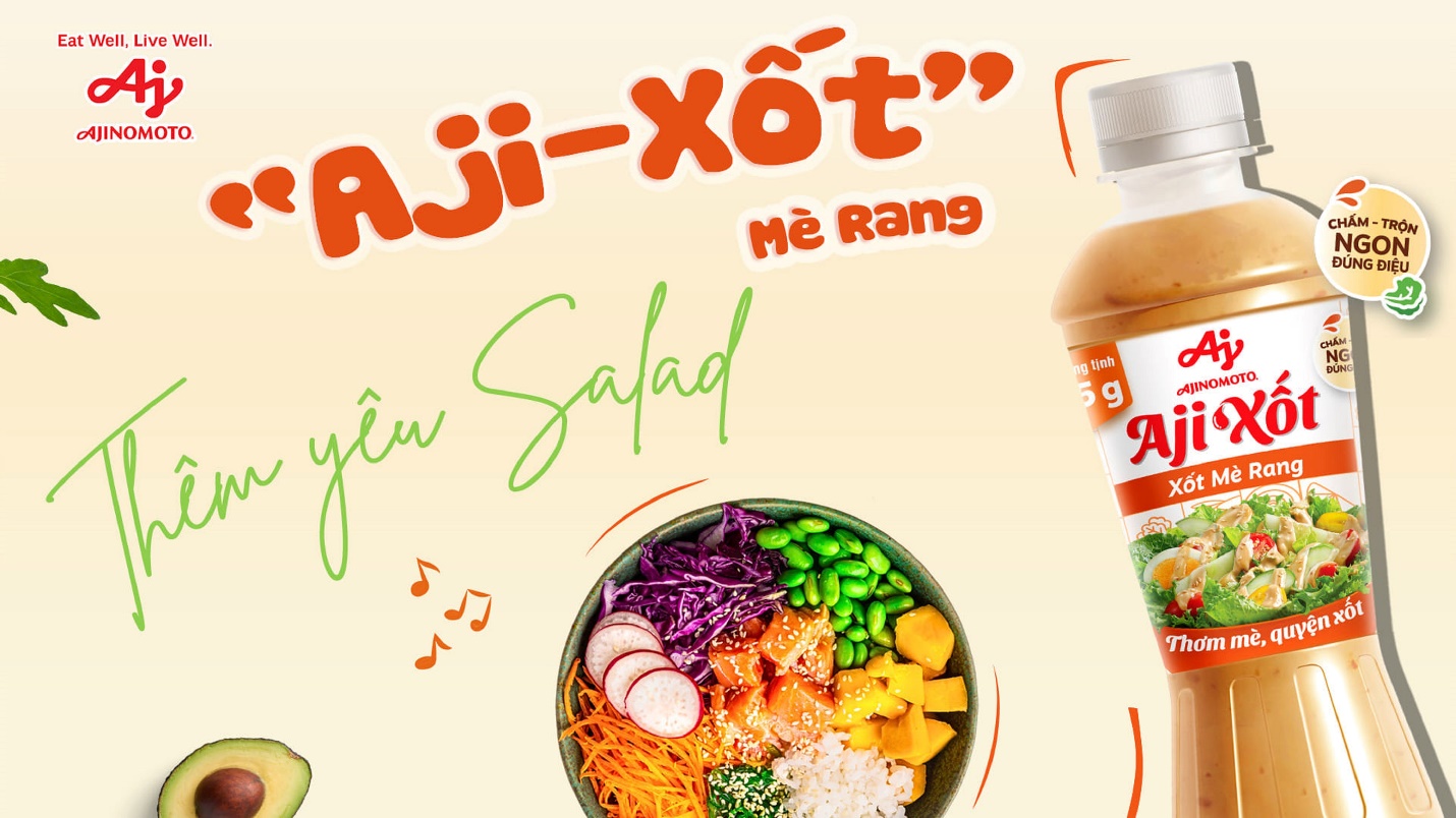 A bowl of salad with a bottle of sauce Description automatically generated