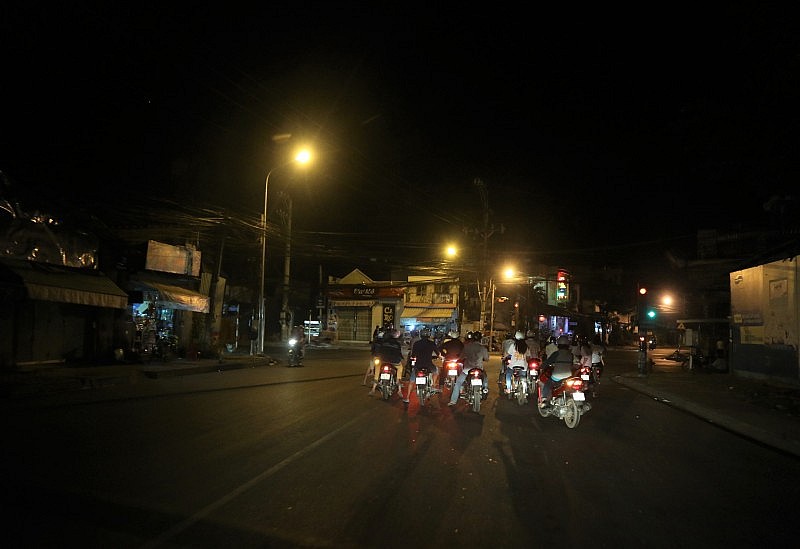 A group of people on motorcycles at night Description automatically generated