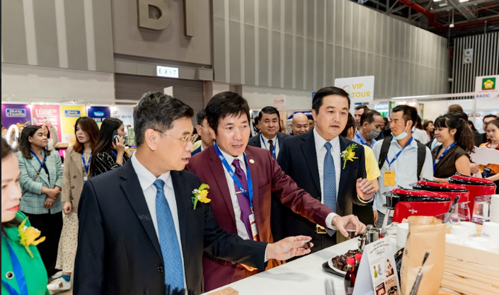 A group of men in suits at a convention Description automatically generated