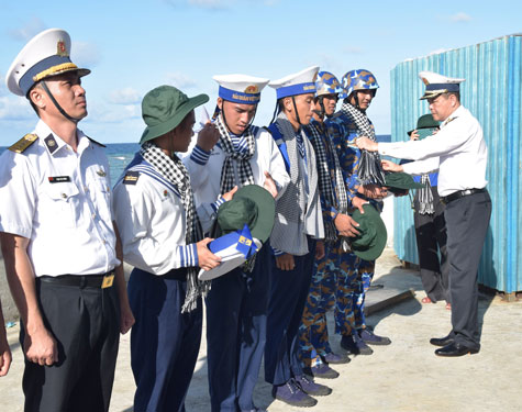 Chuẩn Đ&ocirc; đốc Phạm Như Xu&acirc;n, Ph&oacute; Tư lệnh Qu&acirc;n chủng Hải qu&acirc;n (phải), cho&agrave;ng khăn rằn cho chiến sĩ đảo C&ocirc; Lin