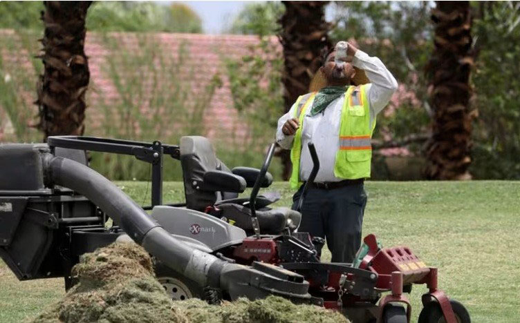 Một người làm vườn uống nước giữa nắng nóng ở Palm Springs, bang California - Mỹ Ảnh: REUTERS