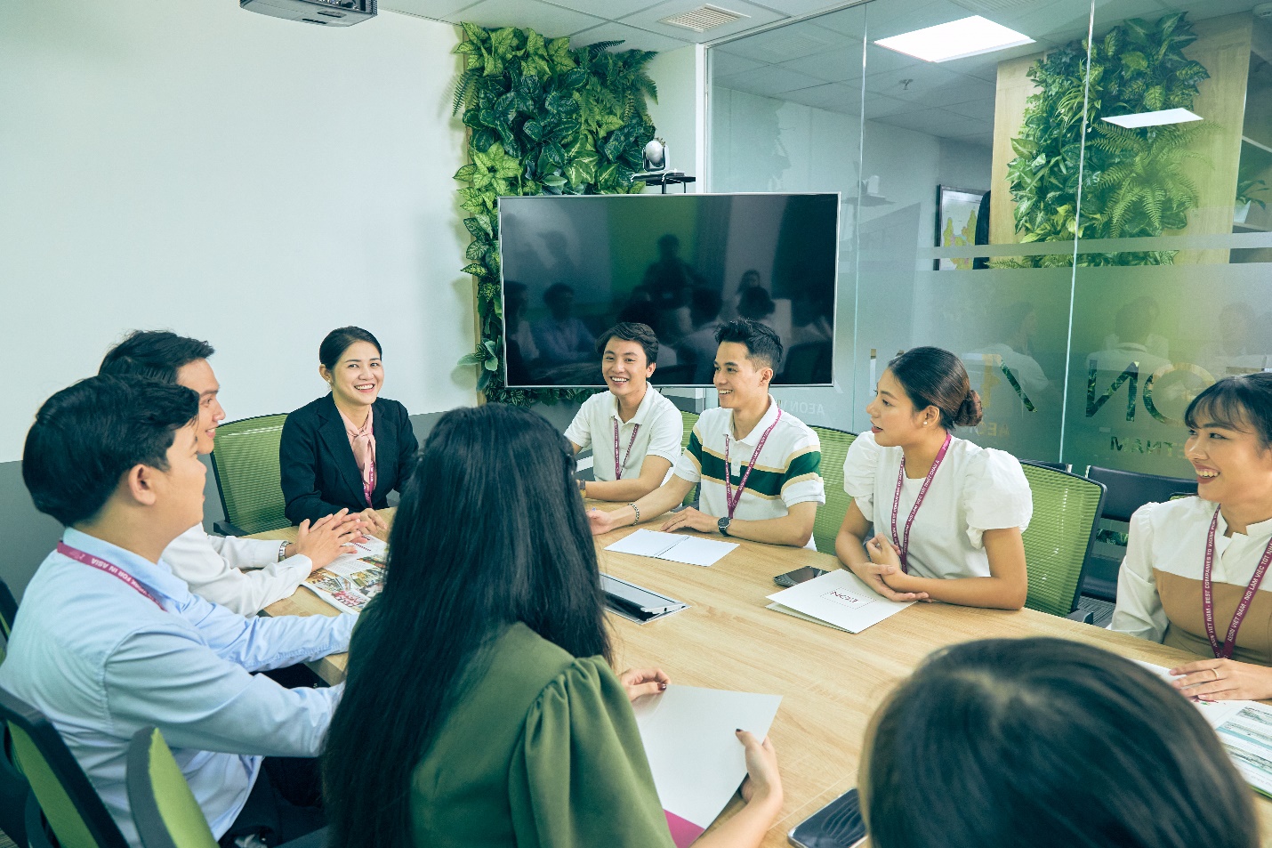 A group of people sitting around a table Description automatically generated