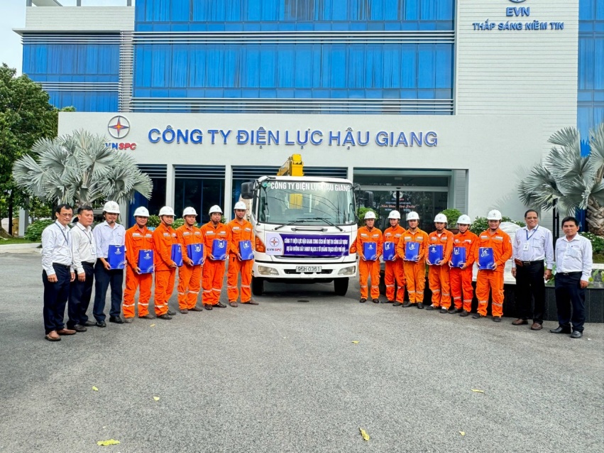 A group of people standing in front of a building Description automatically generated