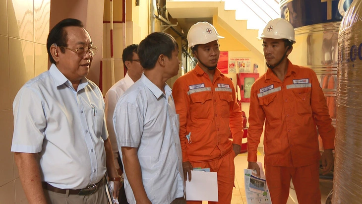 A group of men wearing hard hats Description automatically generated