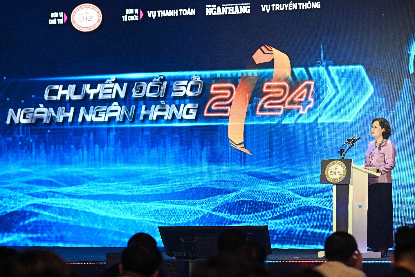 A person standing in front of a large screen Description automatically generated