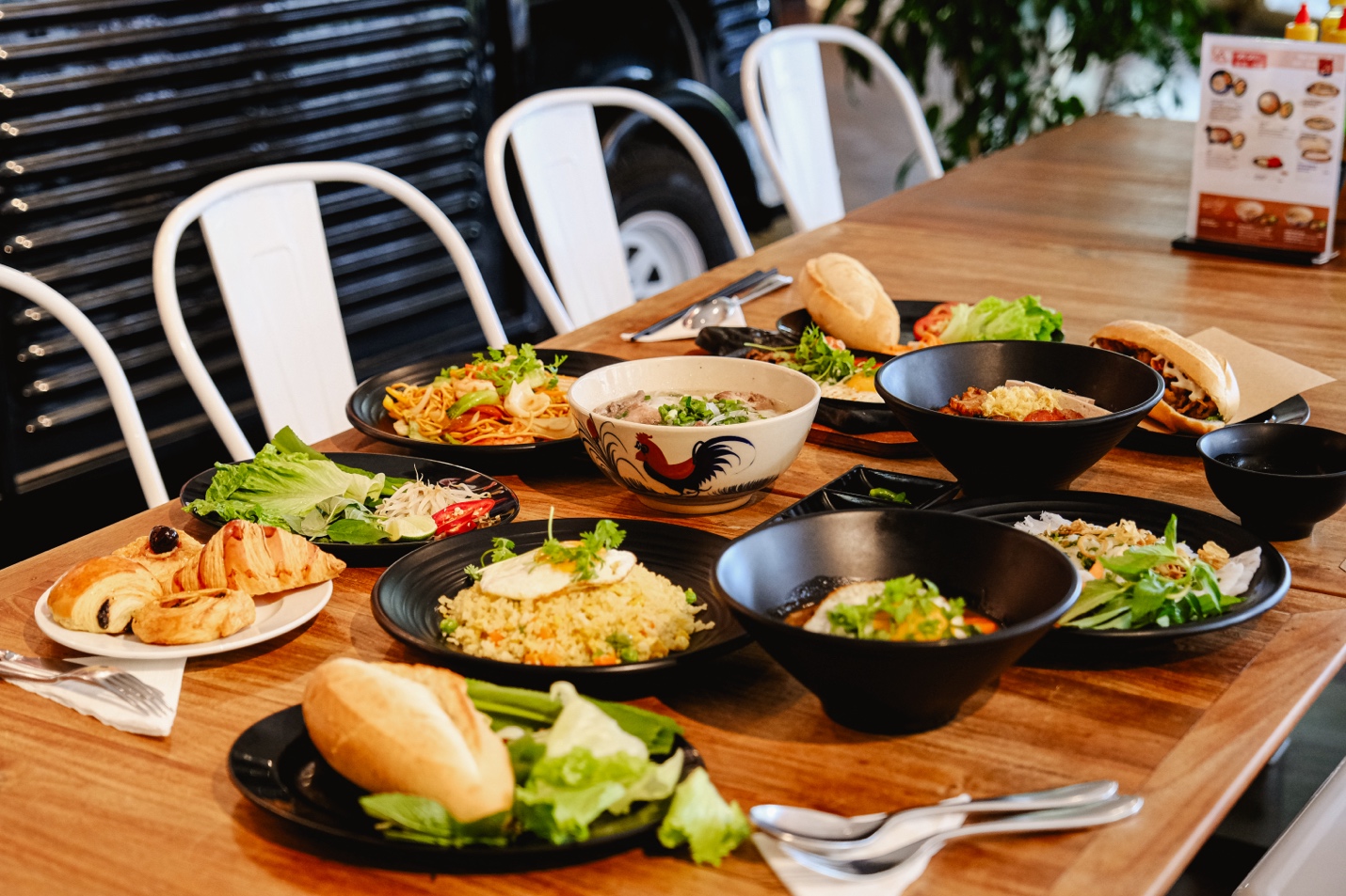 A table with plates of food Description automatically generated